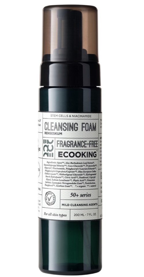 A dark green bottle with a pump contains cleaning foam for skin, labeled as fragrance-free, for mild cleansing.