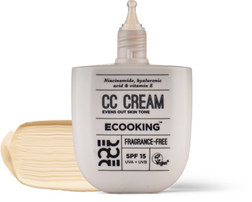 A white bottle of CC cream with a nozzle, lying beside a blob of the cream. It mentions SPF 15 and is fragrance-free.