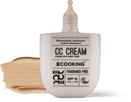 Tube of CC cream with SPF 15, fragrance-free, vegan, and skin tone evening properties, along with a skincare cream.