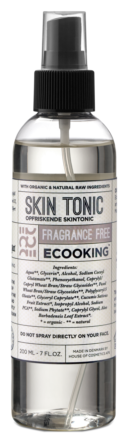 A clear spray bottle with a black cap labeled 'Skin Tonic' and 'Fragrance Free' for skin care. It contains liquid.