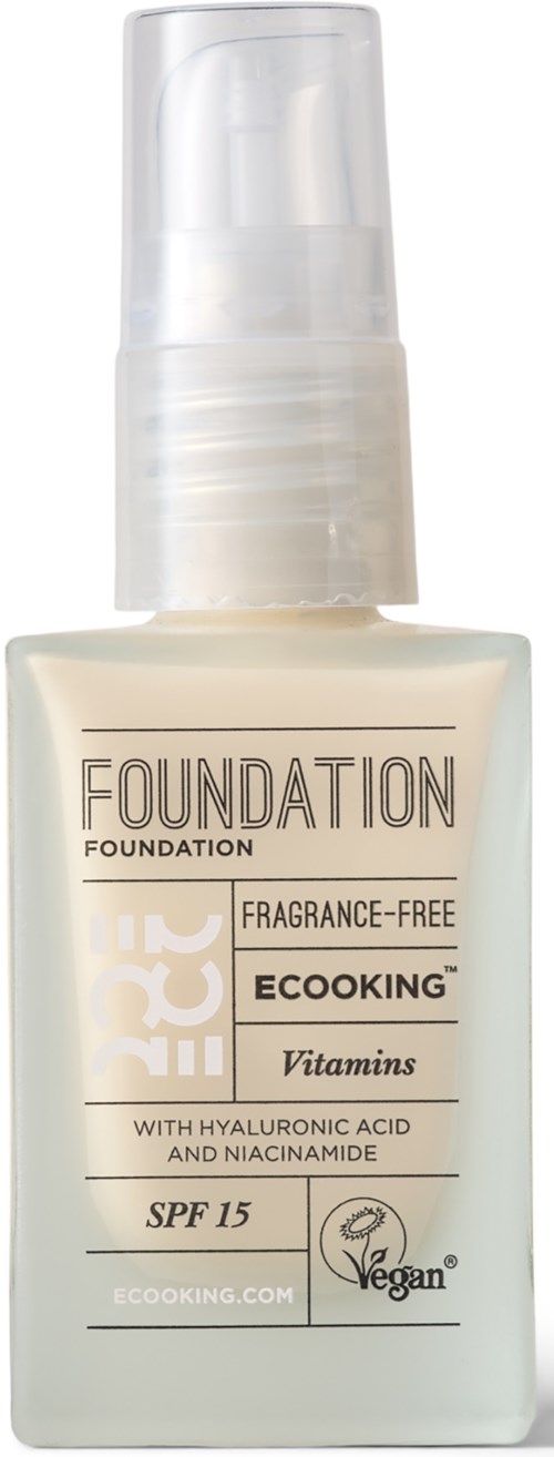A bottle of foundation with SPF 15, fragrance-free, contains vitamins, hyaluronic acid, niacinamide, and is vegan.