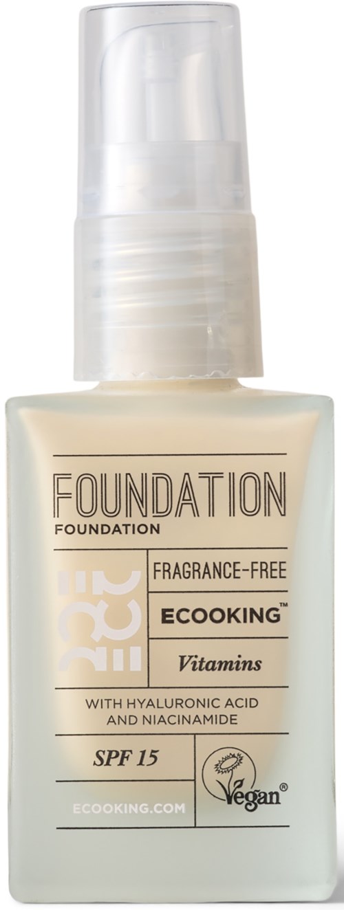 A white bottle of foundation with a spray pump, labeled with SPF 15 and natural ingredients like vitamins.