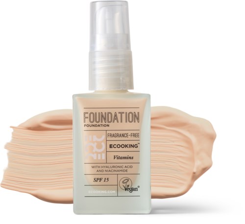 Bottle of fragrance-free foundation with SPF 15 and vitamins, showing swatch of beige shade behind.