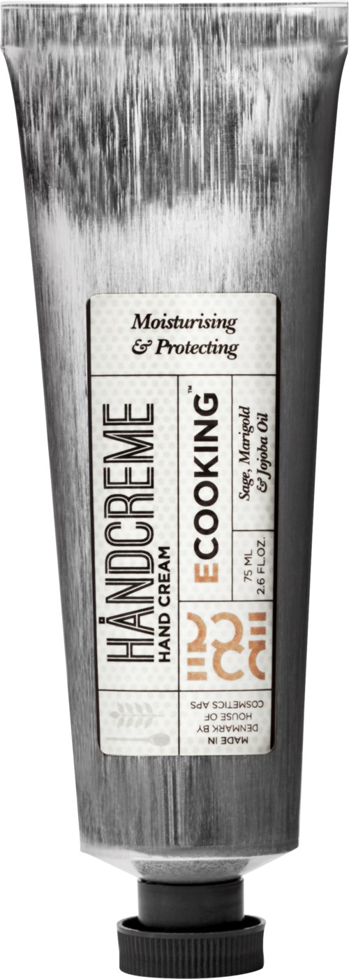 Ein Metallrohr mit einem Etikett für Handcreme, die feuchtigkeitsspendend, schützend und umweltfreundlich ist, mit orange und schwarzem Text.