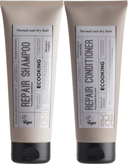 Two beige tubes, one labeled 'Repair Shampoo' and the other 'Repair Conditioner,' meant for normal and dry hair.