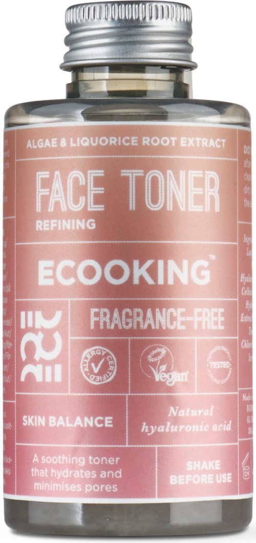 Pink bottle of face toner with labels about natural ingredients, vegan, fragrance-free, and skin benefits.