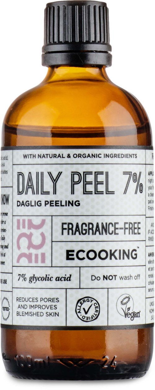 Amber glass bottle with a black cap, label shows daily peel product, fragrance-free, eco-friendly, reduces pores.
