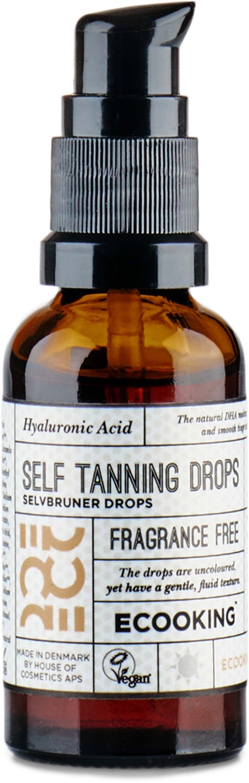 An amber glass bottle with a black pump top, labeled as hyaluronic acid self tanning drops, fragrance free, vegan, and eco-friendly.