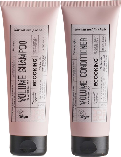 Two pink hair care bottles, one for shampoo and one for conditioner, with black caps and labels.