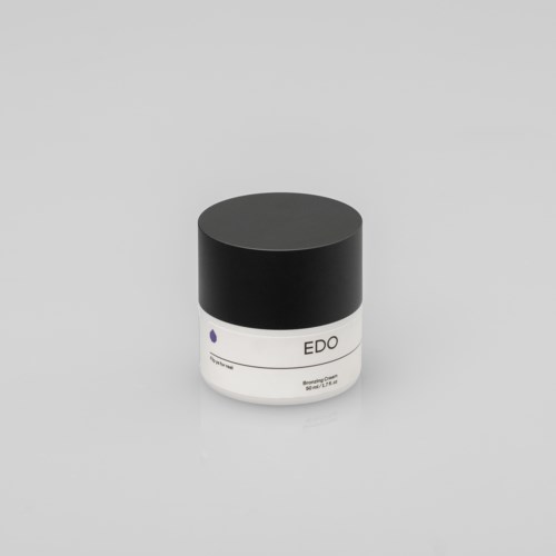 Kleiner weißer Behälter mit schwarzem Deckel, beschriftet mit "EDO". Minimalistisches Design, wahrscheinlich ein Kosmetik- oder Hautpflegeprodukt.