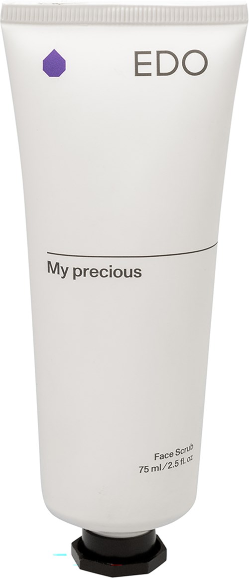 Eine weiße Tube mit Gesichtsscrub, beschriftet 'EDO' und 'My precious', mit einem kleinen lila Hexagon-Logo oben.