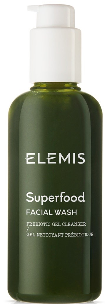 A green bottle of Elemis Superfood Facial Wash with a white pump, labeled as a prebiotic gel cleanser.