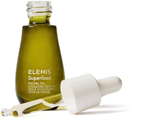 Grüne Flasche für Gesichtspflegeöl mit Tropfer und weißer Kappe, etiketti Elemis Superfood Hydrating Face Oil.