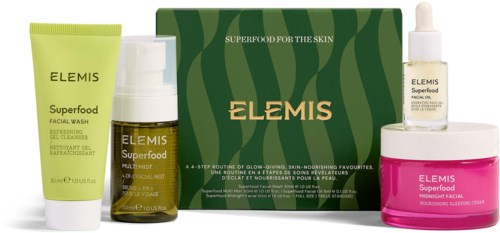 Skincare set with face wash, serum, moisturizer, and a pink cream container in a green box.
