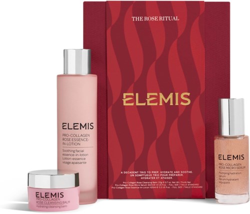 A skincare set with a pink lotion, a small jar, and a peach-toned serum in front of a red box with gold text.