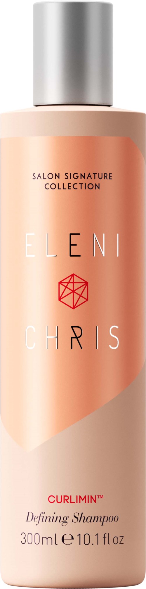 Ein Shampoo-Flasche von Eleni Chris mit einem hellrosa und orangefarbenen Etikett, einem silbernen Verschluss und Produktbeschreibungstext.