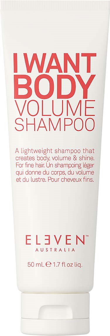 A white tube of shampoo with red text, mentioning volume and body. Brand name is ELEVEN Australia.