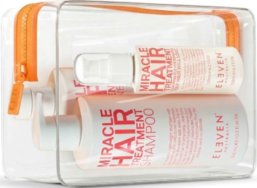 Två flaskor märkta Miracle Hair behandling och schampo i en genomskinlig plastpåse med orange dragkedja.