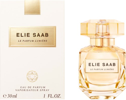 A perfume bottle and box of Elle Saab Le Parfum Lumière, with gold accents and a clear glass bottle.