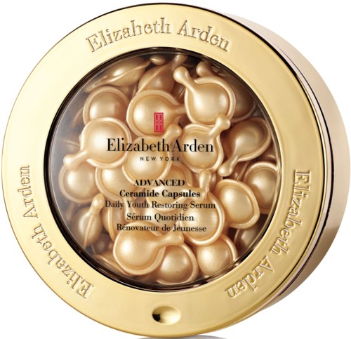 Gold-colored container with capsules labeled as advanced ceramide capsules, containing serum for skin care.