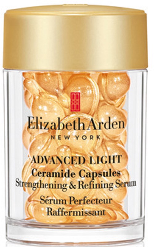 Lasi täynnä kultaisen värisiä kapseleita, merkinnällä Elizabeth Arden Advanced Light Ceramide Capsules, ihonhoitotuote.