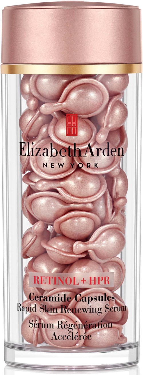 Läpinäkyvä säiliö sisältää vaaleanpunaisia epäsäännöllisen muotoisia kapseleita, joissa Elizabeth Arden -merkki, ihonhoitotuotteisiin.