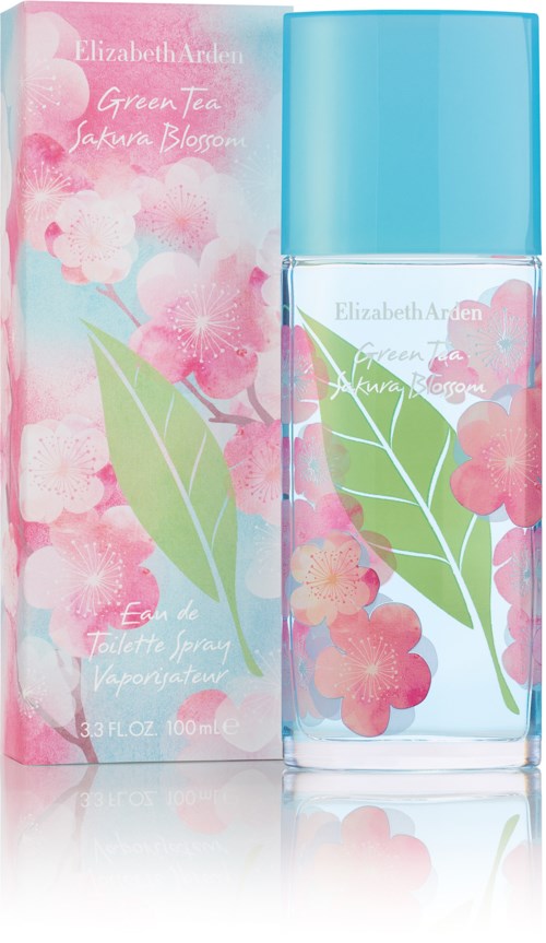 Een parfumfles met roze en groene bloemen en een lichtblauwe dop, naast een doos met vergelijkbare bloemen.