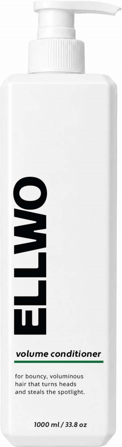 White bottle of volume conditioner with pump, labeled with bold black text, describing its use for bouncy hair.