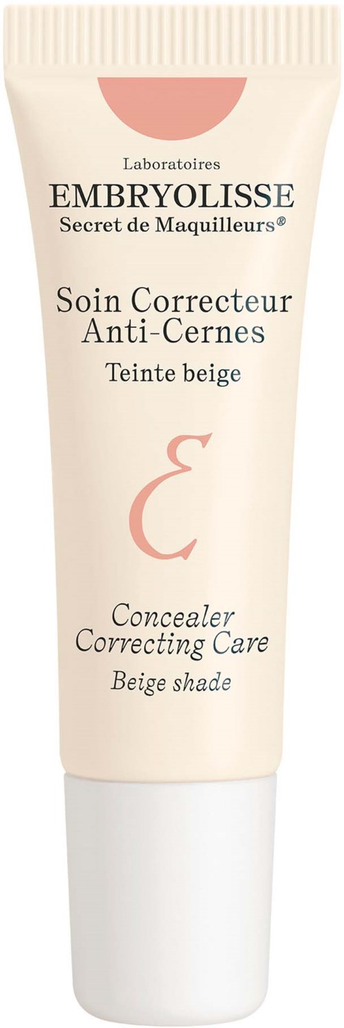 En beige tub med svart och röd text, märkt som en concealer för att täcka mörka ringar, beige nyans.