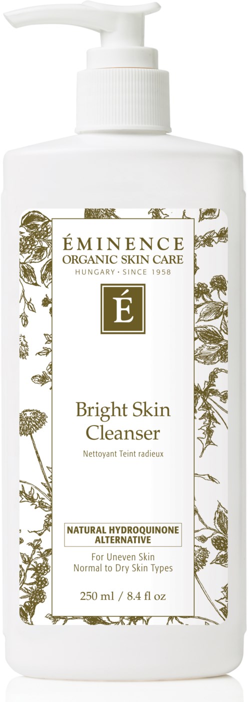 Valkoinen pumppupullo, merkitty 'Eminence Bright Skin Cleanser,' jossa on kultaisia ja kasvi-illustratioita.