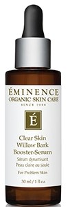 En liten brun flaska med svart lock och vit etikett, innehållande hudvårdssserum, märkt 'Éminence'.