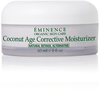 En vit burk med kokosnötsliknande ansiktskräm med gröna texter, märkt 'Éminence Coconut Age Corrective Moisturizer.'
