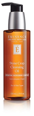 Ruskea pullo, jossa lukee Éminence Stone Crop Cleasing Oil. Siinä on musta painike ja hopea kansi.
