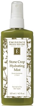 A small spray bottle labeled 'Eminence Stone Crop Hydrating Mist' in green and white with plant illustrations.