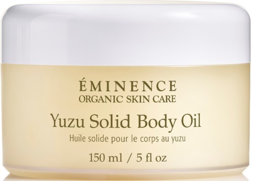 En kremfarget krukke med Eminence Yuzu Solid Body Oil, merket som organisk hudpleie, 150 ml, med hvit lokk.