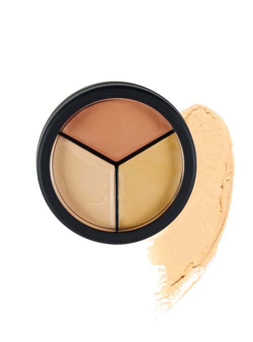 Een kleurcorrigerend make-up palette met drie tinten: perzik, beige en geel, in een ronde zwarte case.