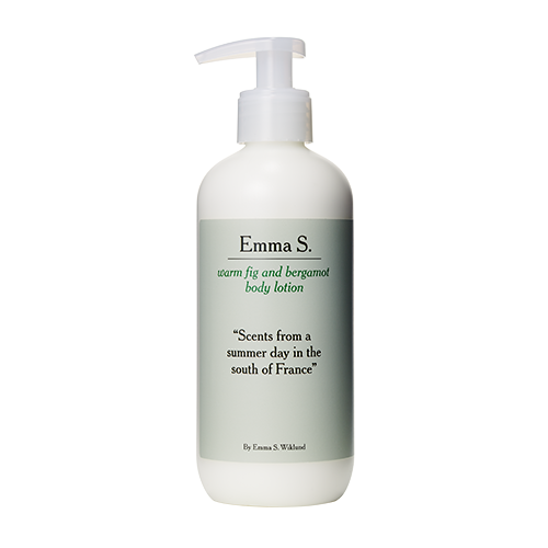 A white lotion bottle with a pump, labeled 'Emma S.', scented with fig and bergamot, inspired by France.