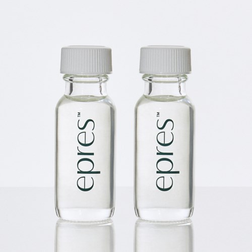 Two small transparent bottles with white caps, labeled "epres" standing side by side.
