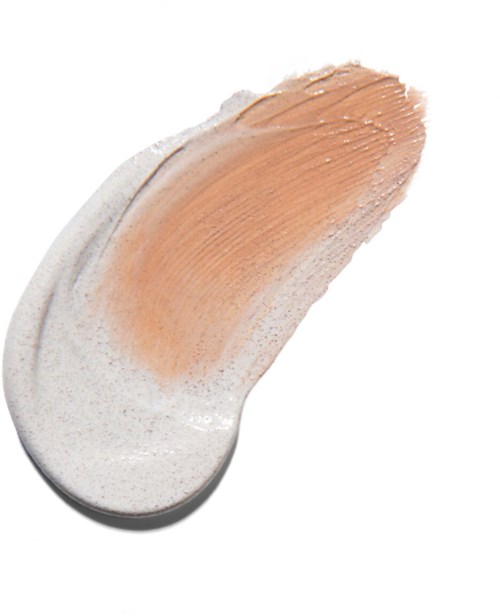 A brush of beige makeup on a white background, with a portion blended outward.