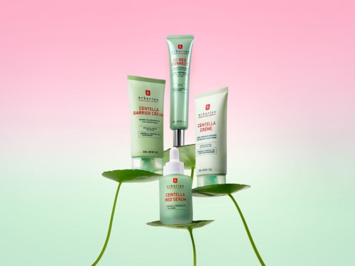 Four skincare products displayed on green leaves against a pink and green background.