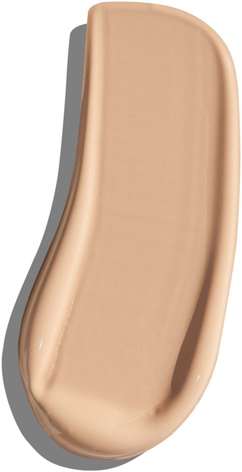 A beige, elongated, curved clay mask with a smooth surface and rounded edges.