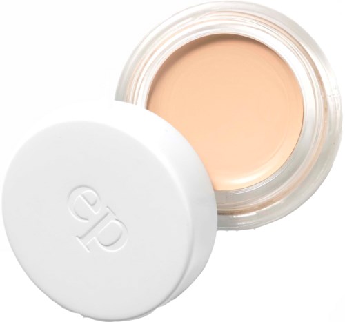 En behållare med ljusbeige kräm med en vit lock bredvid, som visar det öppna innehållet.