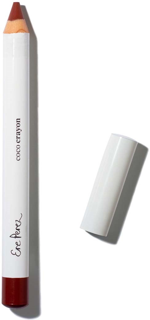 Een witte lippenstift met een rode punt en de losse witte dop ernaast.