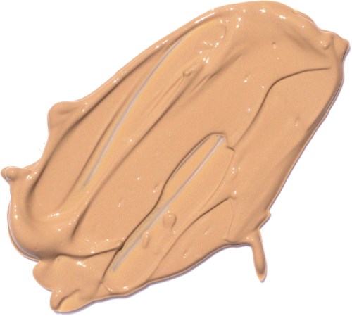 En beige krämig substans, spridd i ett tjockt lager med några ojämna linjer och små bumpar.