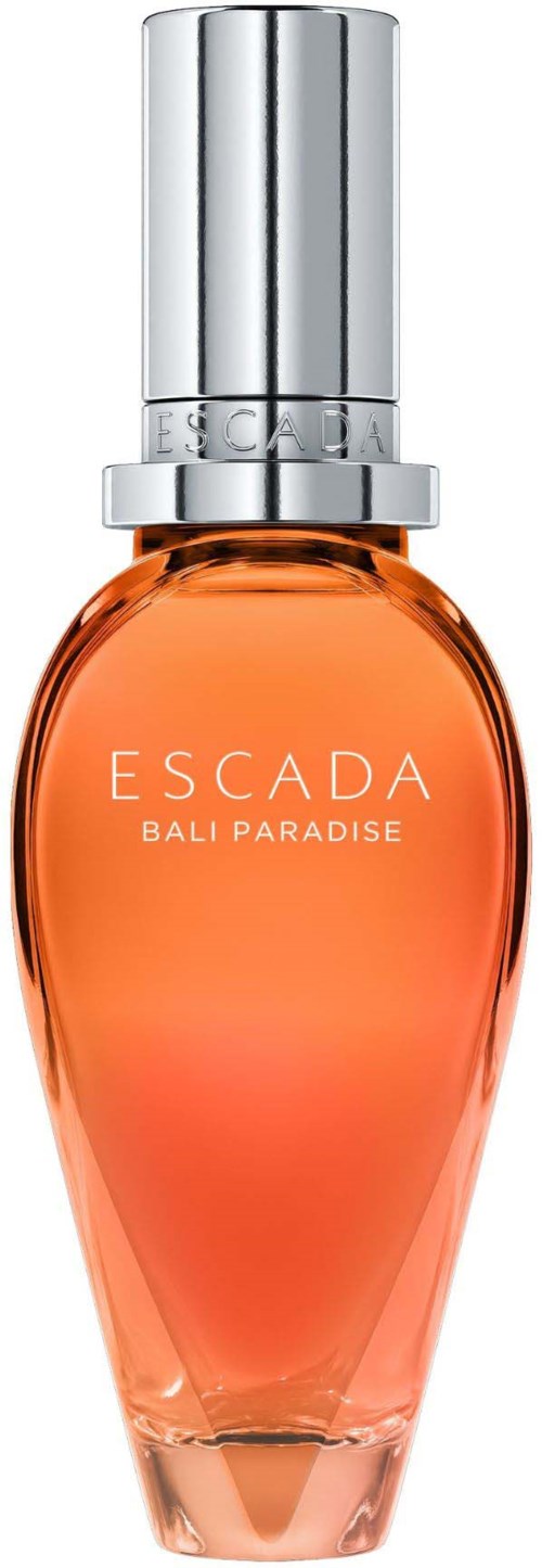 Een parfumfles met oranje vloeistof, gelabeld 'ESCADA BALI PARADISE', zilveren deksel, elegante vorm.