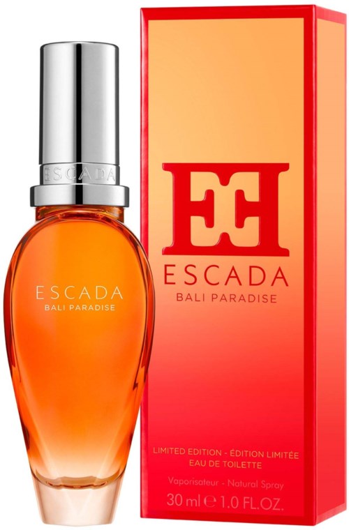 Een parfumfles met oranje vloeistof en zilveren dop, naast een rode en oranje doos met 'ESCADA' en 'BALI PARADISE.'