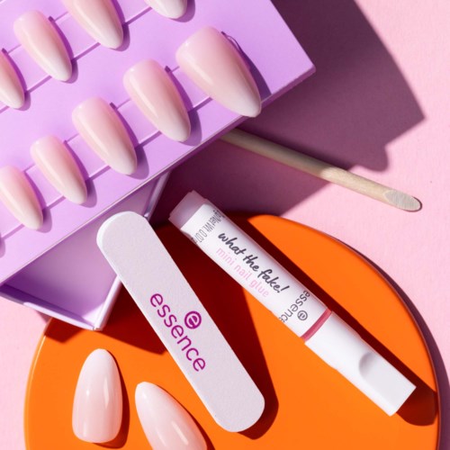 Nagellack und Werkzeuge sind auf einer rosa Oberfläche mit einer lila Aufbewahrungsbox und einer orange Kiste angeordnet.