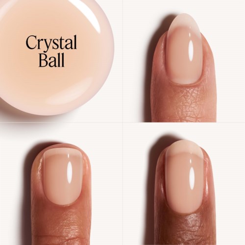 A close-up of a finger with neatly painted, nude-colored nail polish and a round, smooth nail.