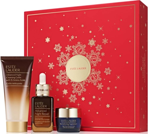 Set of Estee Lauder skincare products for night repair inside a red holiday-themed box with snowflake designs.