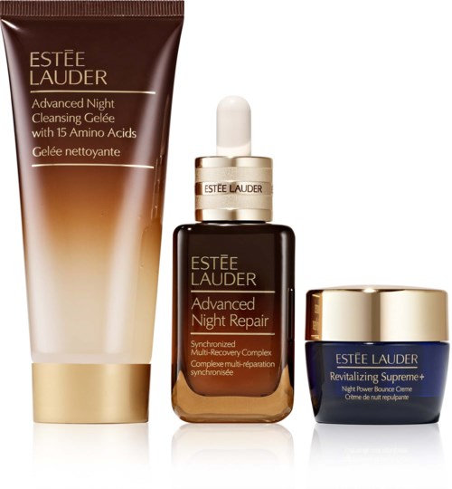 Set of three Estée Lauder skincare products: a cleansing gel, a night repair serum, and a revitalizing cream in blue and gold containers.